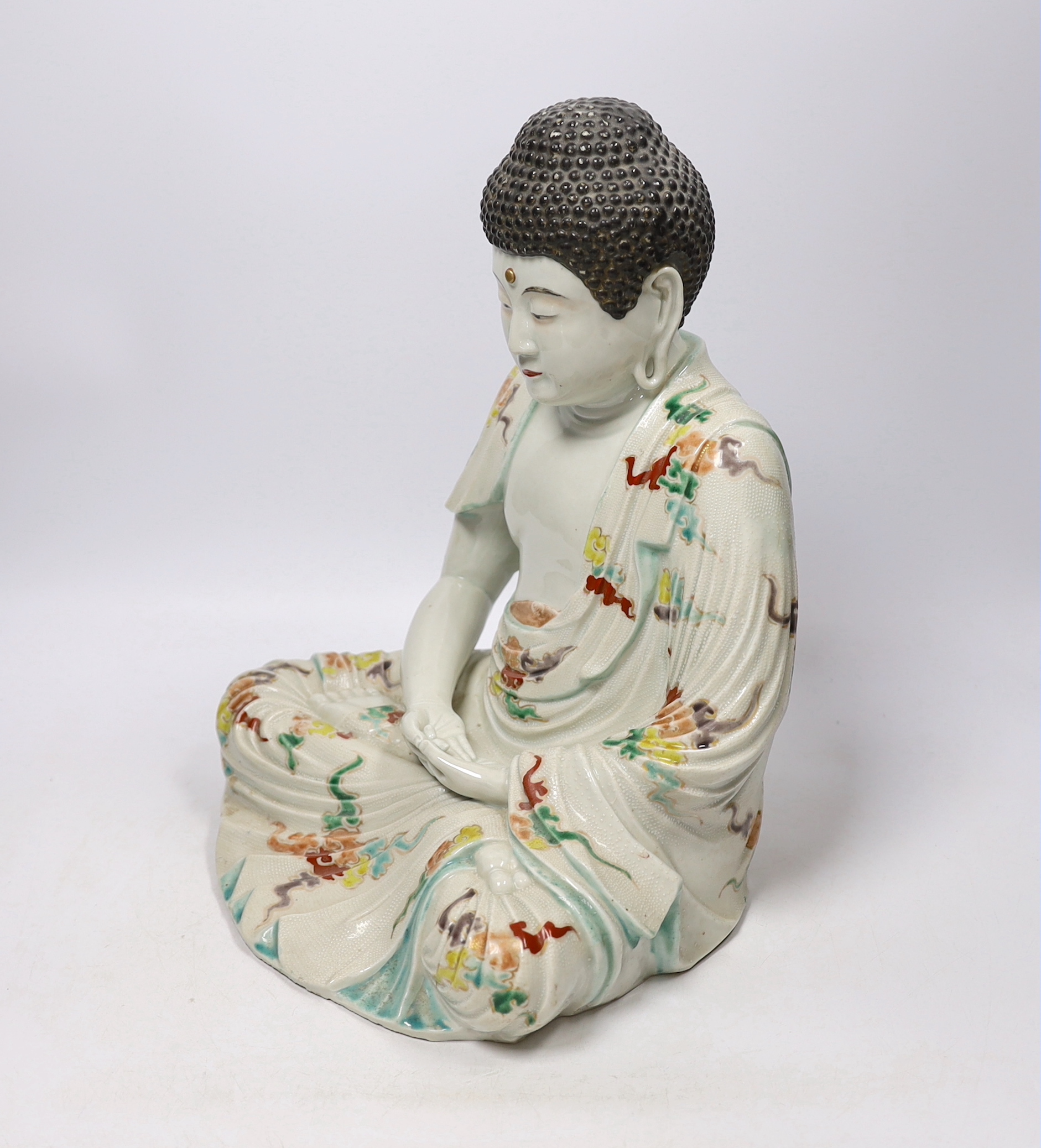 An early 20th century Chinese or Japanese enamelled porcelain figure of Buddha, 33cm